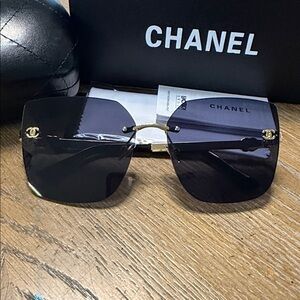 CHANEL Women’s Rimless Sunglasses in Black with Gold Accents